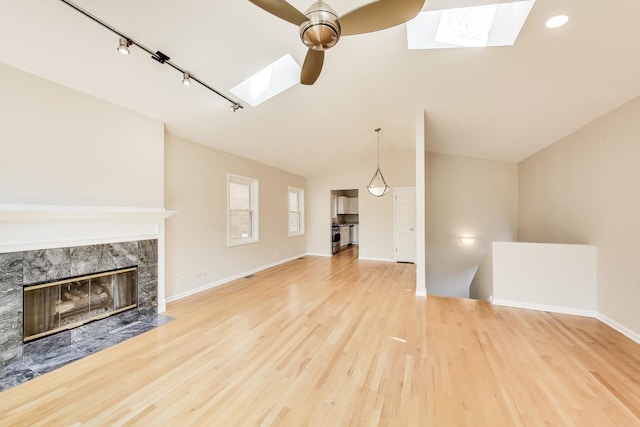 3319 N Seminary Ave Unit 3, Chicago, IL 60657 - unfurnished living room with a skylight, ceiling fan, lofted ceiling, wood finished floors, and a premium fireplace