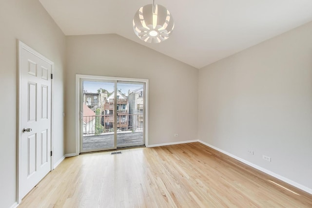 3319 N Seminary Ave Unit 3, Chicago, IL 60657 - unfurnished room with a chandelier, light wood-style flooring, and vaulted ceiling
