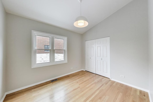 3319 N Seminary Ave Unit 3, Chicago, IL 60657 - unfurnished bedroom featuring light wood-style flooring, vaulted ceiling, and a closet