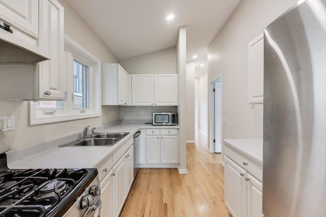 3319 N Seminary Ave Unit 3, Chicago, IL 60657 - kitchen featuring stainless steel appliances, under cabinet range hood, light countertops, light wood-style floors, and white cabinets