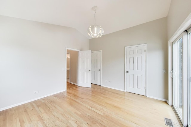 3319 N Seminary Ave Unit 3, Chicago, IL 60657 - unfurnished bedroom featuring a chandelier, light wood finished floors, and vaulted ceiling