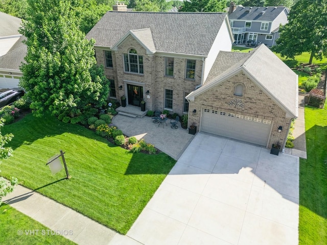 33 Citation Cir, Wheaton, IL 60189 - view of front of home featuring brick siding, a front lawn, a garage, concrete driveway, and a shingled roof