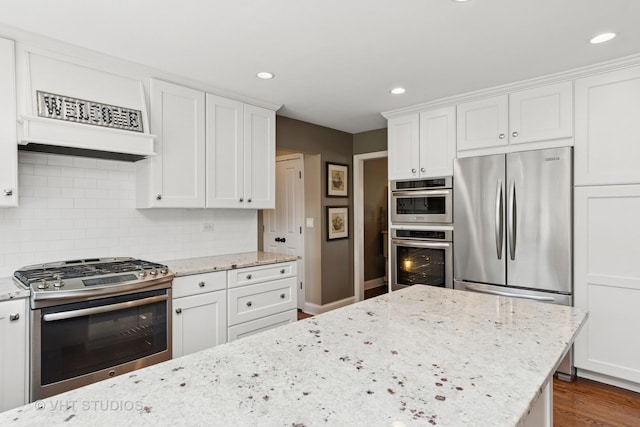 33 Citation Cir, Wheaton, IL 60189 - kitchen featuring stainless steel appliances, white cabinets, backsplash, recessed lighting, and light stone countertops