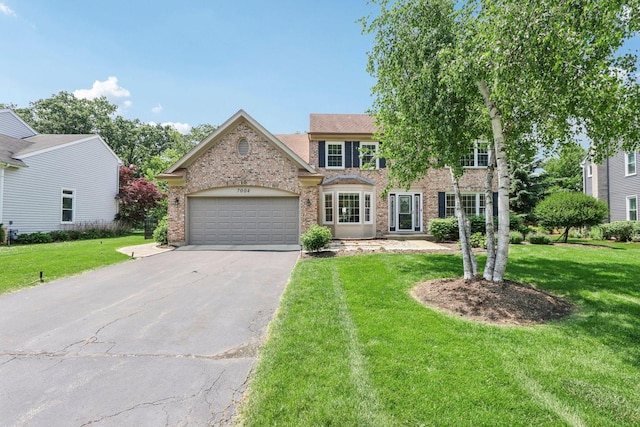 7004 Bennington Dr, Gurnee, IL 60031 - view of front of house with driveway, a front yard, and a garage