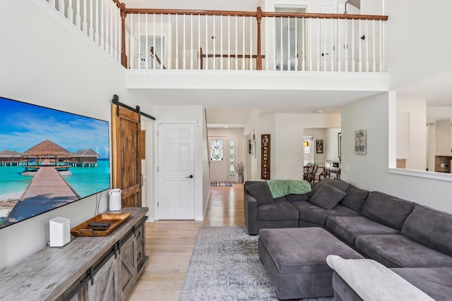 7004 Bennington Dr, Gurnee, IL 60031 - living area with light wood-style flooring, a high ceiling, and a barn door