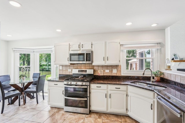 7004 Bennington Dr, Gurnee, IL 60031 - kitchen with stainless steel appliances, plenty of natural light, white cabinetry, and recessed lighting