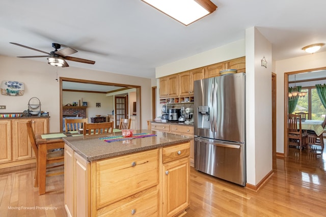 420 Fairway View Dr, Algonquin, IL 60102 - kitchen featuring stainless steel fridge with ice dispenser, light wood-style flooring, a kitchen island, ceiling fan, and dark stone counters