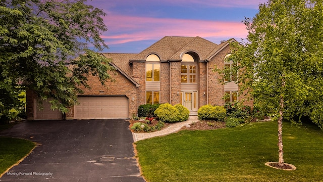 420 Fairway View Dr, Algonquin, IL 60102 - french country home with asphalt driveway, a lawn, brick siding, and an attached garage