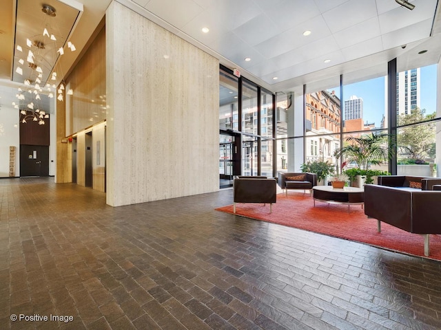 1560 N Sandburg Ter Unit 2403J, Chicago, IL 60610 - building lobby featuring expansive windows and a towering ceiling