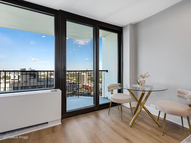1560 N Sandburg Ter Unit 2403J, Chicago, IL 60610 - dining space featuring a wall of windows and wood finished floors