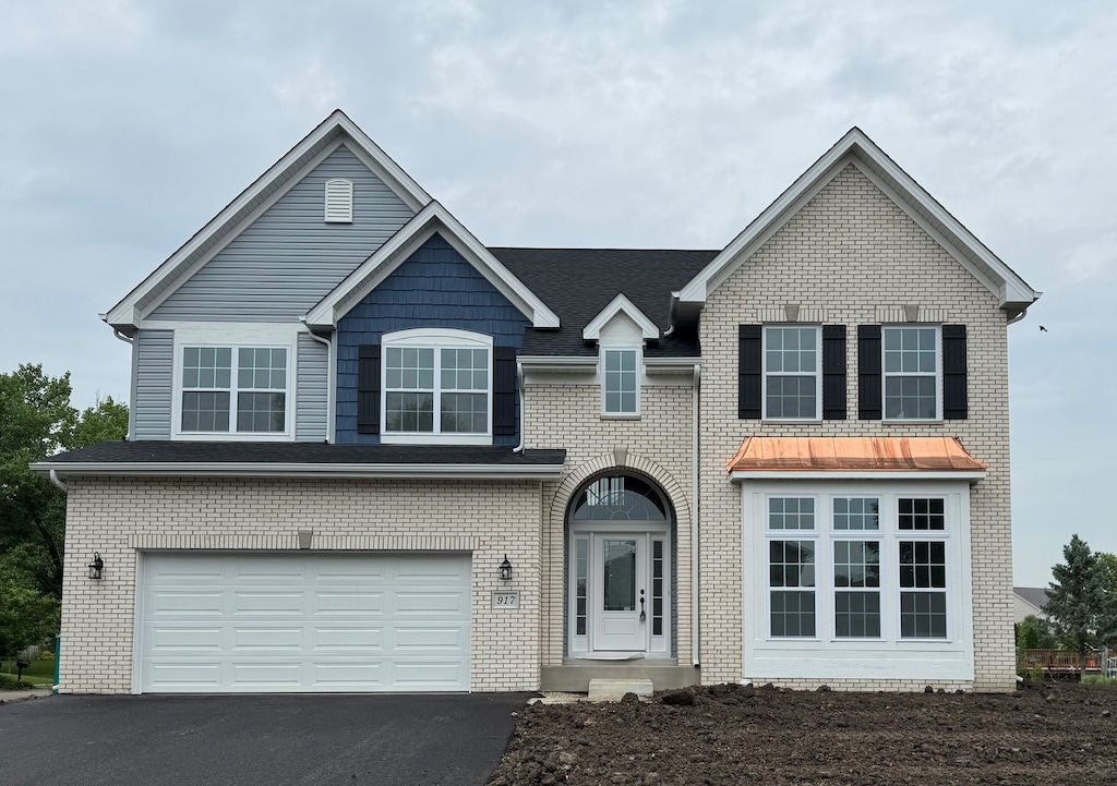 917 Rivers Edge Dr, Minooka, IL 60447 - traditional-style house featuring driveway, an attached garage, and brick siding