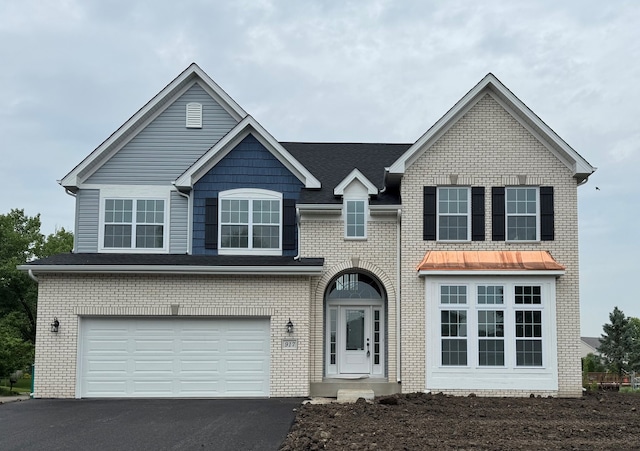 917 Rivers Edge Dr, Minooka, IL 60447 - traditional-style house featuring driveway, an attached garage, and brick siding