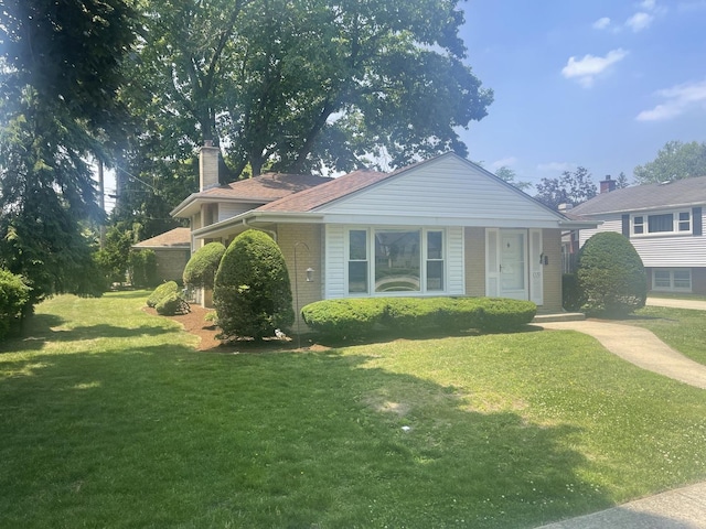 1530 S Greenwood Ave, Park Ridge, IL 60068 - view of front of house with a front lawn, a chimney, and brick siding