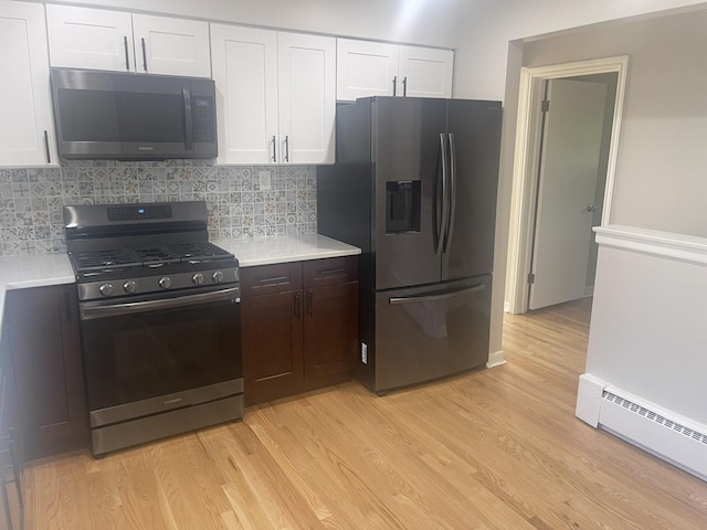 1530 S Greenwood Ave, Park Ridge, IL 60068 - kitchen with stainless steel appliances, a baseboard heating unit, light countertops, light wood-style floors, and white cabinetry
