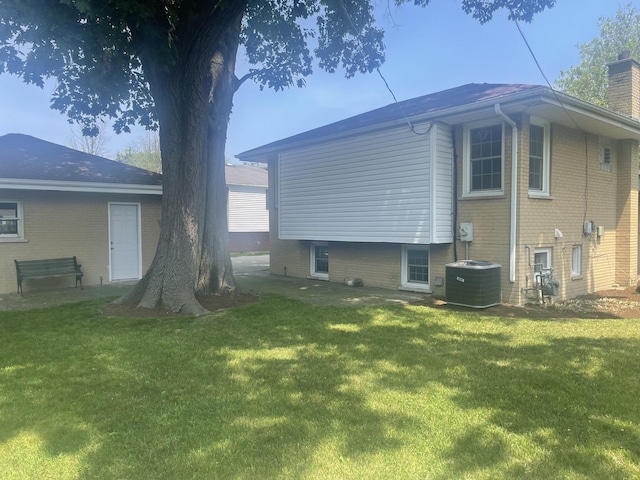 1530 S Greenwood Ave, Park Ridge, IL 60068 - back of property with a yard, brick siding, and a chimney
