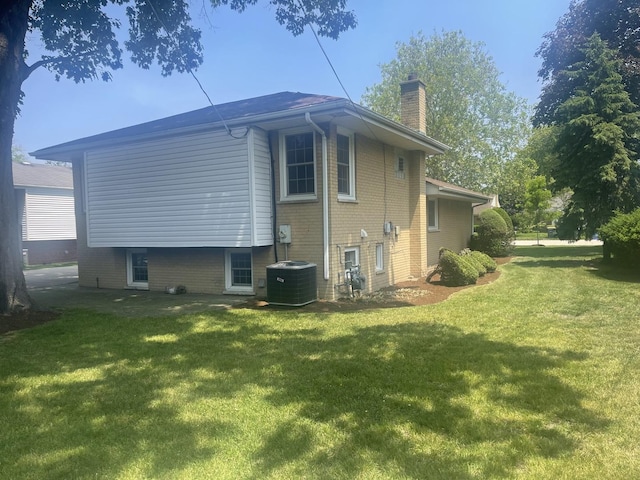 1530 S Greenwood Ave, Park Ridge, IL 60068 - view of side of property with a chimney, a yard, and brick siding