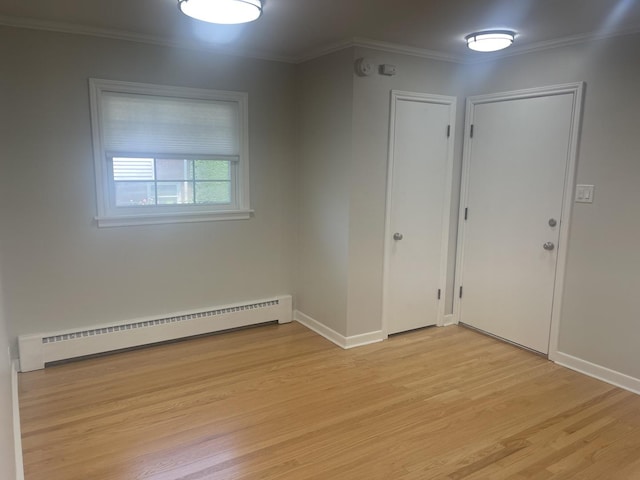 1530 S Greenwood Ave, Park Ridge, IL 60068 - empty room with baseboard heating, light wood-style flooring, crown molding, and a smoke detector