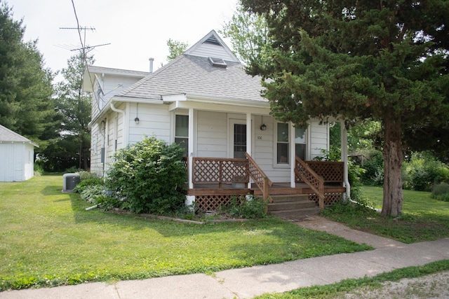 108 N Grove St, Harmon, IL 61042 - bungalow-style house with a porch, roof with shingles, and a front lawn
