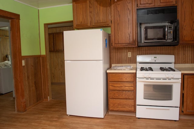 108 N Grove St, Harmon, IL 61042 - kitchen featuring white appliances, light countertops, washer / clothes dryer, light wood-style floors, and brown cabinets