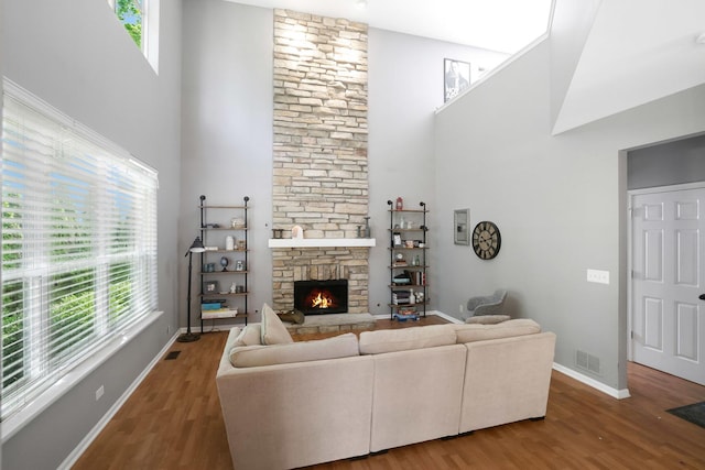 10628 Great Plaines Dr, Huntley, IL 60142 - living area with plenty of natural light, wood finished floors, a high ceiling, and a stone fireplace