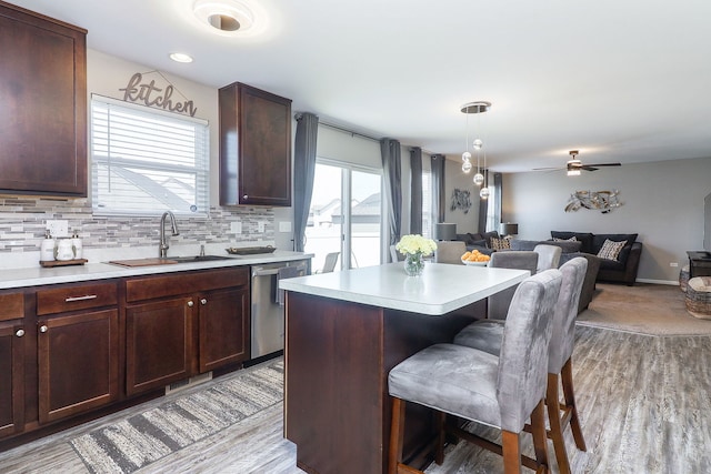 1307 Colaric Dr, Joliet, IL 60431 - kitchen with stainless steel dishwasher, a kitchen bar, open floor plan, and light countertops