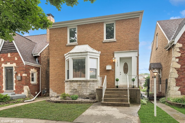 1628 Kenilworth Ave, Berwyn, IL 60402 - view of front of house with a chimney, a front lawn, and brick siding