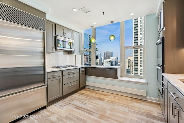 25 E Superior St Unit 2402, Chicago, IL 60611 - kitchen featuring stainless steel appliances, gray cabinets, light wood-style flooring, a view of city, and recessed lighting