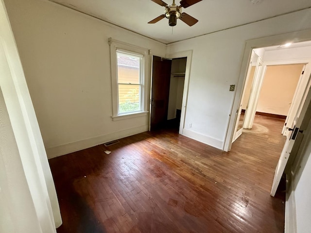 505 N Fair St, Champaign, IL 61821 - unfurnished bedroom with wood-type flooring, a closet, and ceiling fan