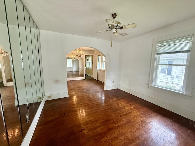 505 N Fair St, Champaign, IL 61821 - empty room featuring arched walkways, wood finished floors, and ceiling fan