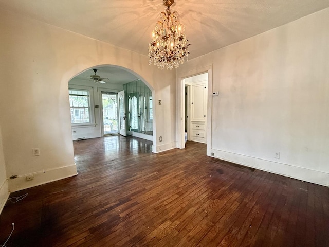 505 N Fair St, Champaign, IL 61821 - empty room featuring arched walkways, dark wood-style flooring, a chandelier, and ceiling fan