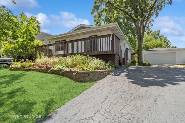 304 Pheasant Trl, Lake In The Hills, IL 60156 - view of front of property featuring a detached garage, a front lawn, an outdoor structure, and a wooden deck