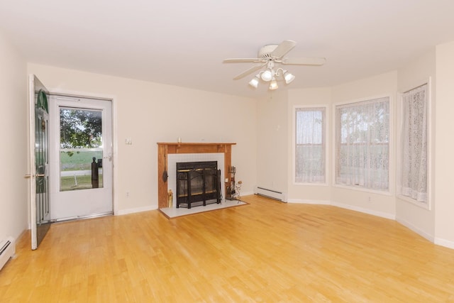 22998 E 2800 N Rd, Odell, IL 60460 - unfurnished living room with a baseboard heating unit, light wood finished floors, ceiling fan, and a tiled fireplace