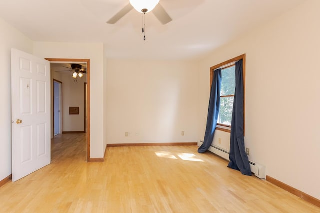 22998 E 2800 N Rd, Odell, IL 60460 - empty room featuring ceiling fan, light wood finished floors, and a baseboard radiator