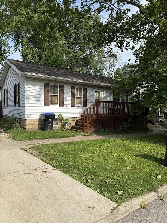 409 Catherine St, Bloomington, IL 61701 - single story home with a wooden deck and a front lawn