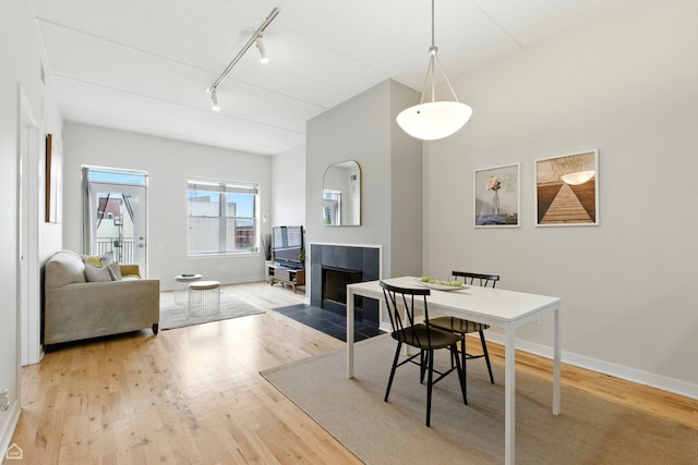 1515 N Wells St Unit 7D, Chicago, IL 60610 - dining room featuring track lighting, a fireplace, and wood finished floors