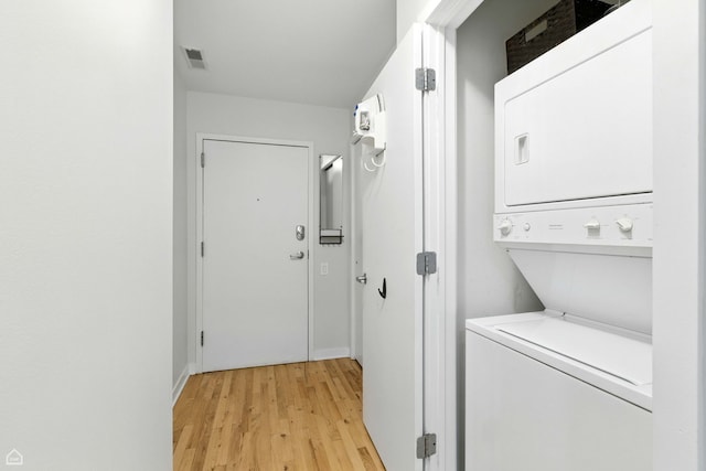 1515 N Wells St Unit 7D, Chicago, IL 60610 - laundry area featuring stacked washer and clothes dryer and light wood-type flooring