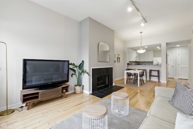 1515 N Wells St Unit 7D, Chicago, IL 60610 - living room with rail lighting, light wood-type flooring, and a fireplace