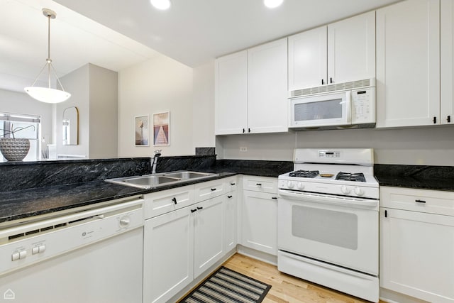 1515 N Wells St Unit 7D, Chicago, IL 60610 - kitchen with white appliances, white cabinets, light wood-type flooring, dark stone countertops, and recessed lighting