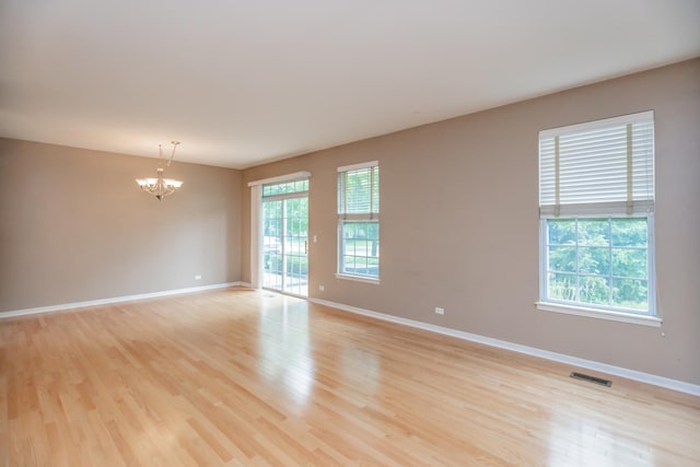 133 W Park Ave Unit A, Sugar Grove, IL 60554 - spare room featuring a chandelier and light wood-type flooring