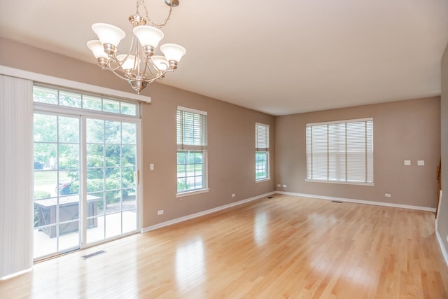 133 W Park Ave Unit A, Sugar Grove, IL 60554 - spare room featuring a chandelier and light wood-style floors