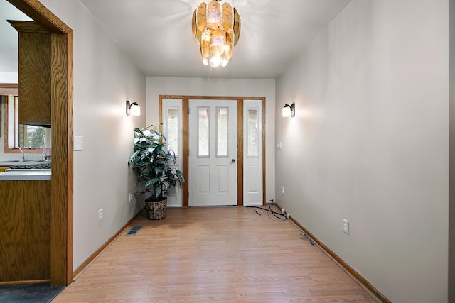 1177 N 6250w Rd, Bonfield, IL 60913 - foyer entrance with light wood-style flooring and a chandelier