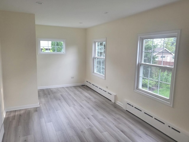 9321 S 81st Ct, Hickory Hills, IL 60457 - unfurnished room featuring a baseboard heating unit and light wood finished floors