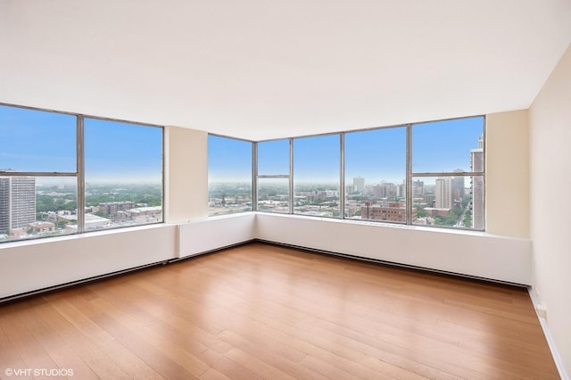 5757 N Sheridan Rd Unit 20J, Chicago, IL 60660 - spare room with a view of city, wood finished floors, and plenty of natural light