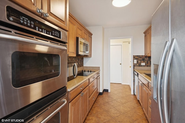 5757 N Sheridan Rd Unit 20J, Chicago, IL 60660 - kitchen with black appliances, backsplash, light countertops, light tile patterned flooring, and brown cabinets