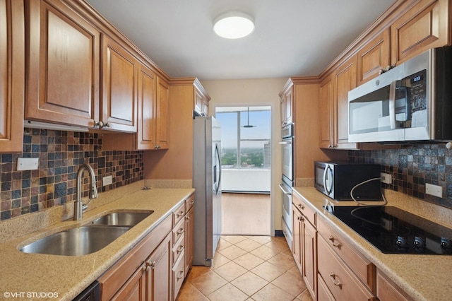 5757 N Sheridan Rd Unit 20J, Chicago, IL 60660 - kitchen with black appliances, light tile patterned floors, decorative backsplash, brown cabinets, and light stone countertops