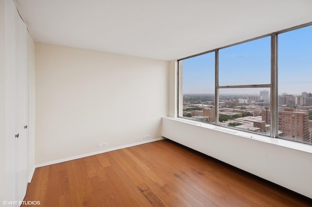 5757 N Sheridan Rd Unit 20J, Chicago, IL 60660 - spare room with wood finished floors and a city view