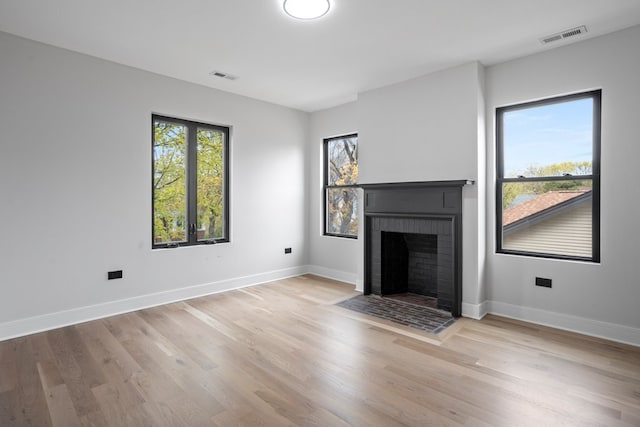 2305 W 111th Pl, Chicago, IL 60643 - unfurnished living room with a brick fireplace and light wood-type flooring