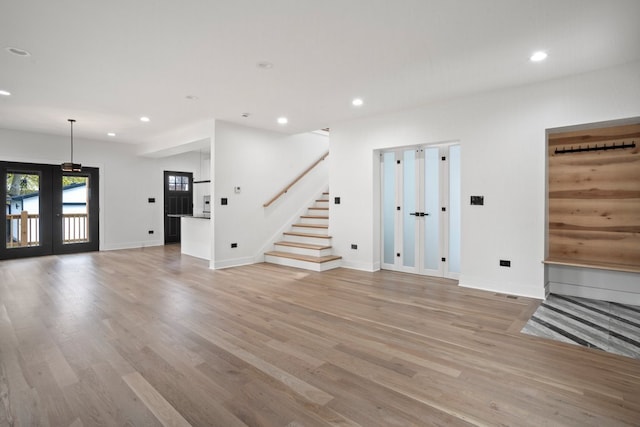 2305 W 111th Pl, Chicago, IL 60643 - unfurnished living room with recessed lighting, light wood-style floors, and stairs