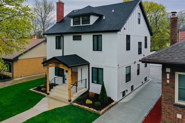 2305 W 111th Pl, Chicago, IL 60643 - view of front of home with board and batten siding, roof with shingles, and a chimney