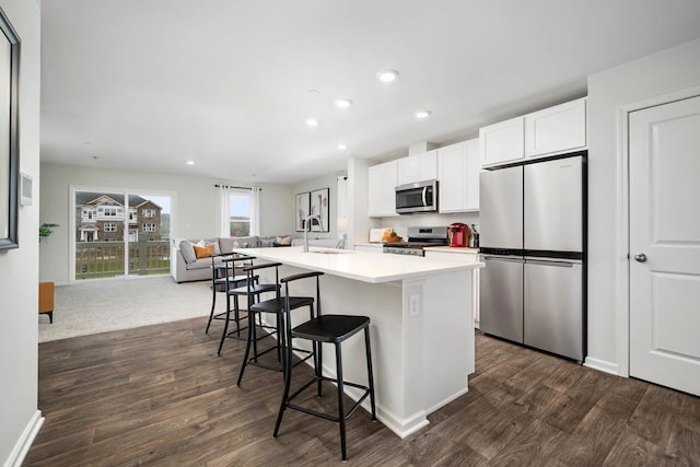 6335 Ulster Dr, Tinley Park, IL 60477 - kitchen featuring stainless steel appliances, open floor plan, dark wood-style floors, an island with sink, and recessed lighting
